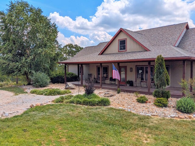 view of front of home featuring a front yard and a porch