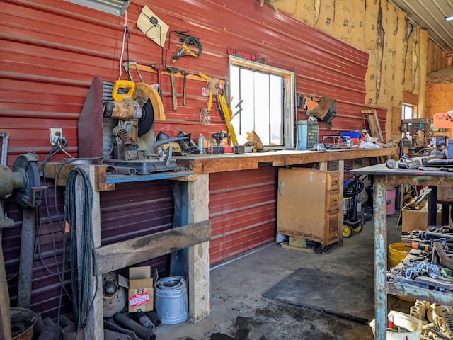 miscellaneous room with concrete floors and a workshop area