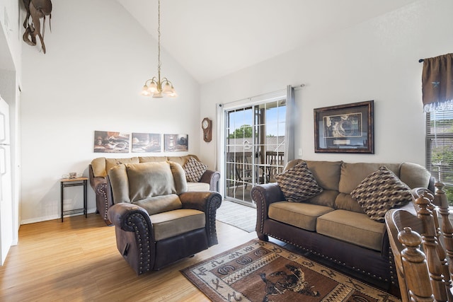 living room featuring wood-type flooring, an inviting chandelier, high vaulted ceiling, and a wealth of natural light