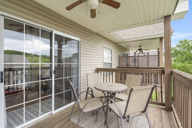 wooden balcony with a wooden deck and ceiling fan