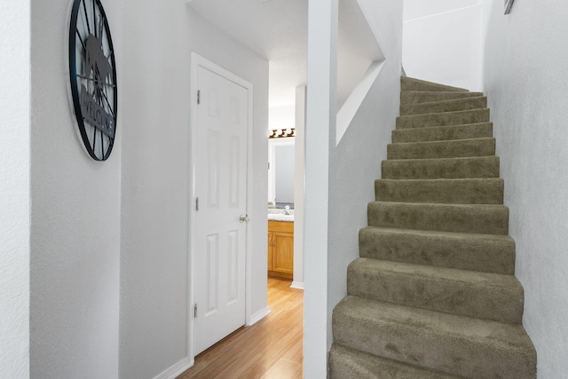 stairs with hardwood / wood-style flooring