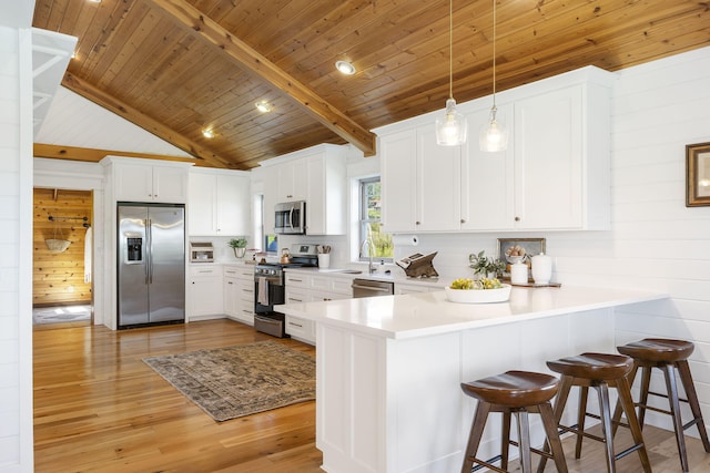 kitchen featuring stainless steel appliances, wooden ceiling, pendant lighting, white cabinetry, and light hardwood / wood-style flooring