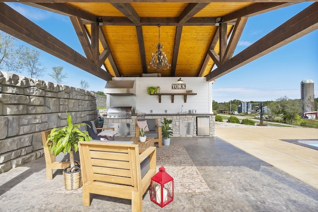 view of patio featuring an outdoor kitchen, sink, and a grill