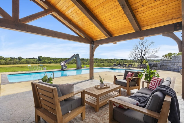 view of patio / terrace featuring a fenced in pool, a gazebo, and an outdoor hangout area