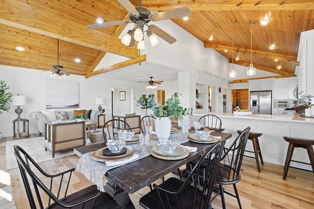 dining space featuring high vaulted ceiling, beam ceiling, wooden ceiling, and light hardwood / wood-style floors