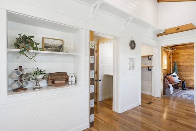 interior space featuring wooden walls and hardwood / wood-style floors