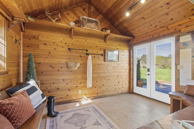 doorway to outside with french doors, wood walls, light tile patterned floors, and wooden ceiling