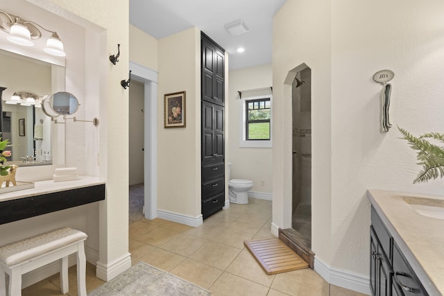 bathroom featuring a shower, tile patterned floors, vanity, and toilet