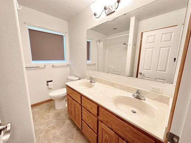 bathroom with a shower with shower curtain, double vanity, toilet, and a sink
