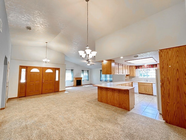 kitchen with white dishwasher, kitchen peninsula, light carpet, a notable chandelier, and vaulted ceiling