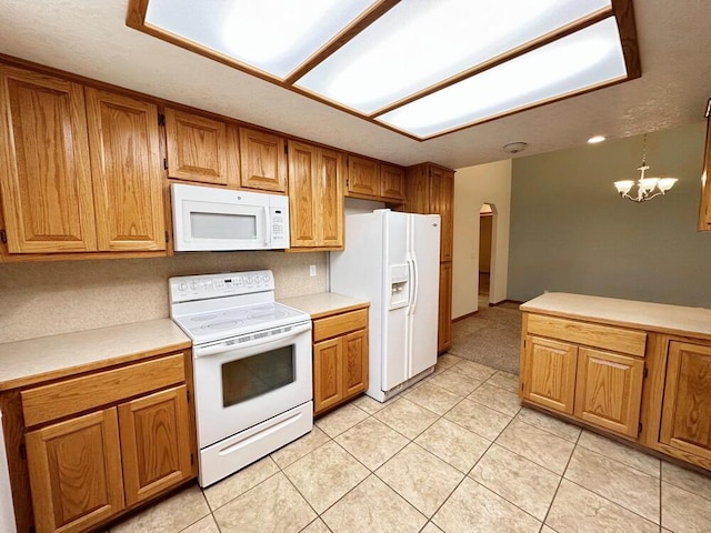 kitchen featuring brown cabinetry, arched walkways, white appliances, and light countertops