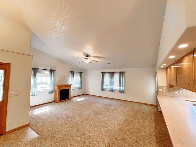unfurnished living room with recessed lighting, a ceiling fan, light carpet, baseboards, and a fireplace
