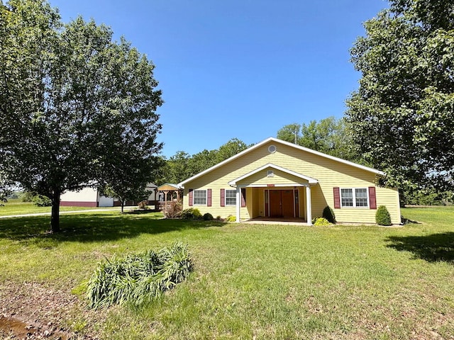 single story home featuring a garage and a front lawn