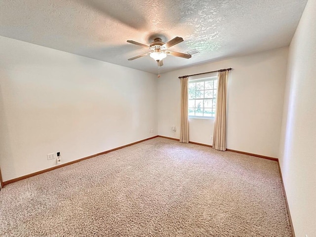 unfurnished room featuring light carpet, visible vents, a textured ceiling, and ceiling fan