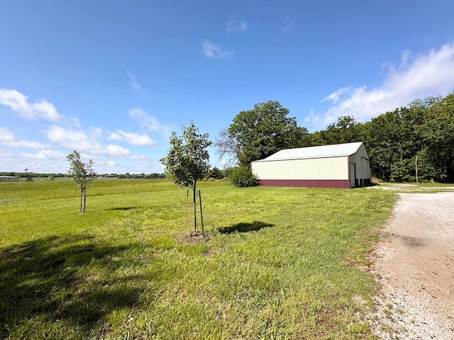 view of yard with a rural view and an outdoor structure