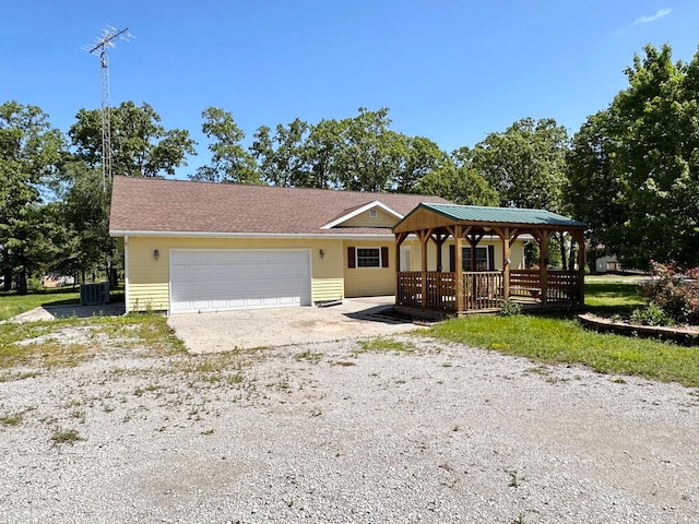 single story home featuring central AC unit, a garage, and a gazebo