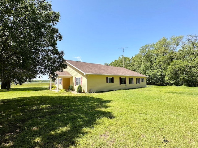 view of side of property with a yard