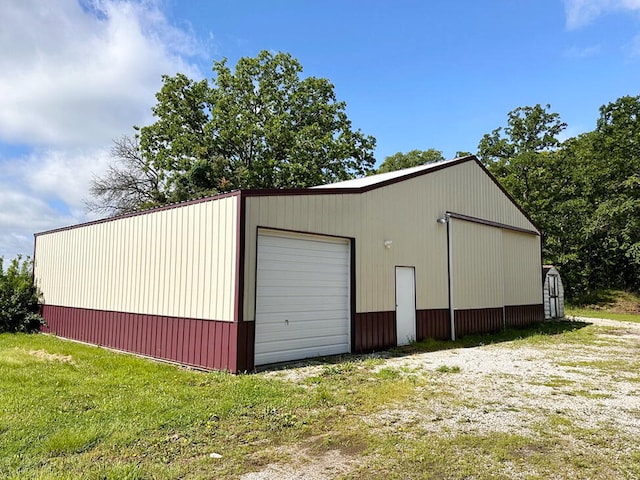 garage featuring a lawn