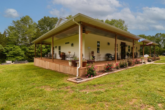 view of home's exterior with ceiling fan and a lawn