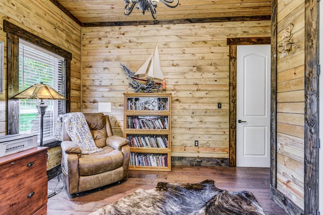 sitting room with wood-type flooring, wooden ceiling, and wooden walls