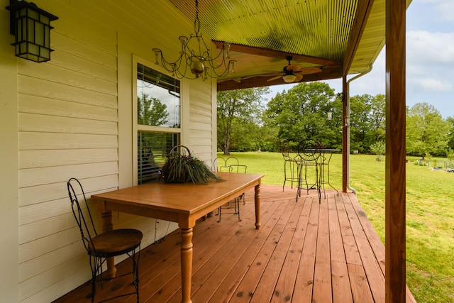 wooden terrace featuring a yard and ceiling fan