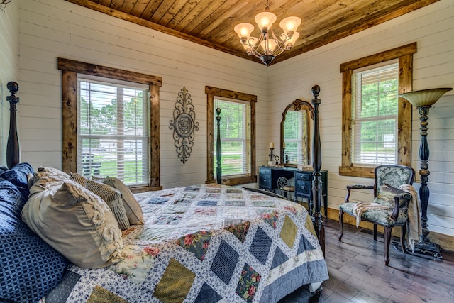 bedroom with wooden walls, hardwood / wood-style floors, a chandelier, and wooden ceiling