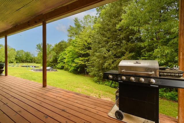 deck with a lawn and area for grilling