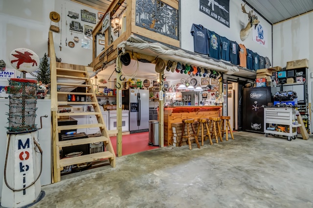 interior space with stainless steel refrigerator with ice dispenser