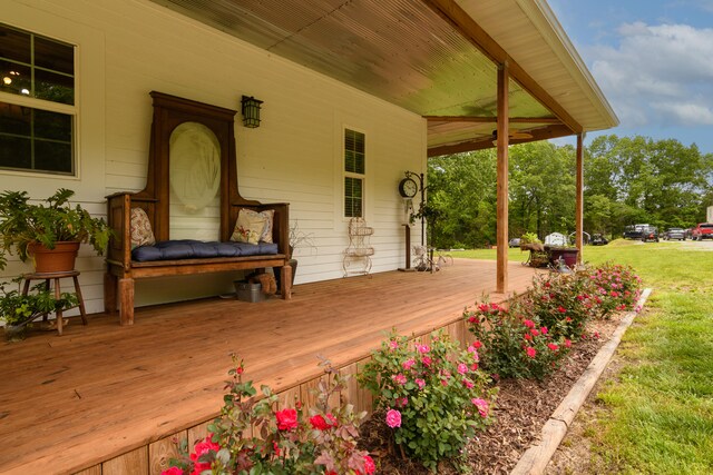 deck featuring a porch and a yard