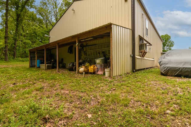 view of side of home with an outdoor structure and a yard