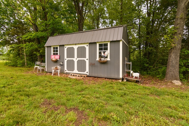 view of outbuilding with a yard