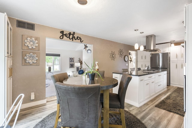 dining space with light wood-type flooring