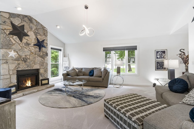 carpeted living room featuring a stone fireplace and lofted ceiling