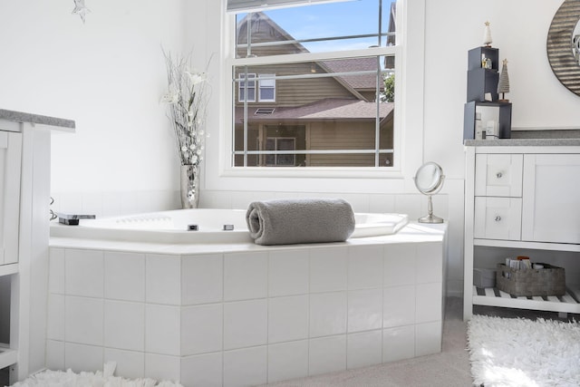 bathroom featuring a relaxing tiled tub