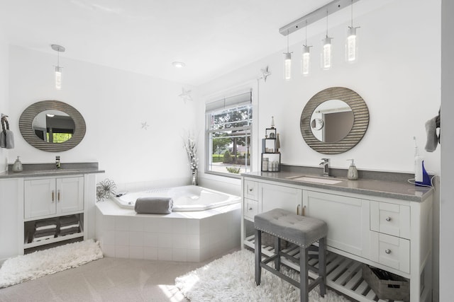 bathroom with tiled bath and vanity