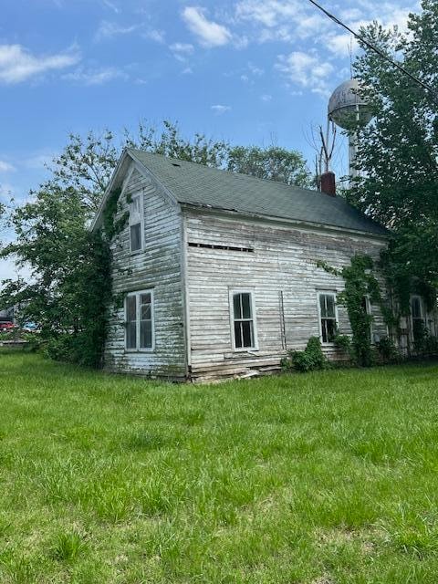 view of home's exterior with a lawn