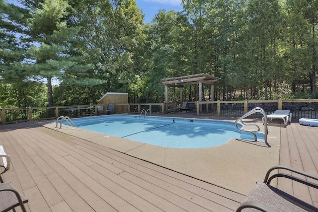 view of pool featuring a deck and a pergola