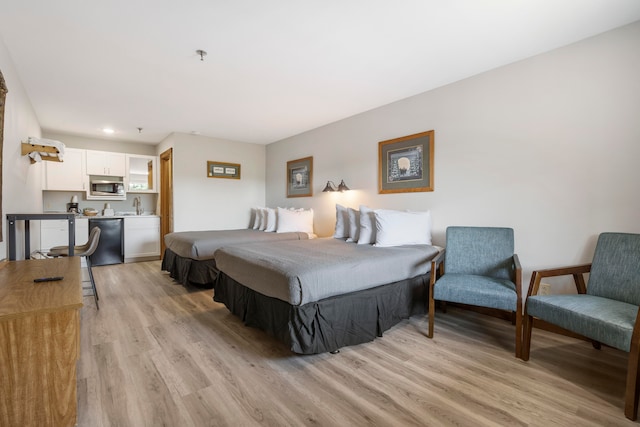 bedroom featuring light hardwood / wood-style flooring and sink