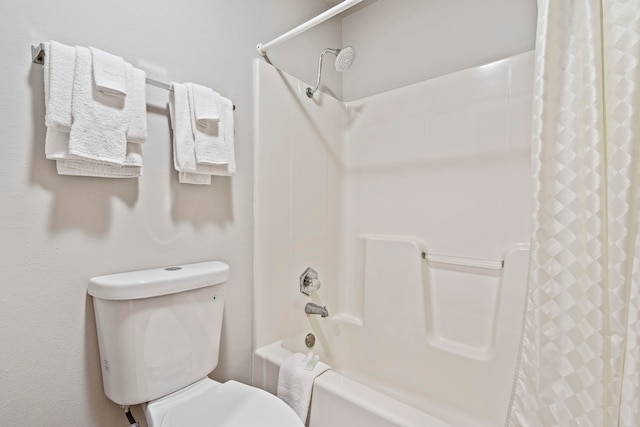 bathroom featuring shower / bath combo and toilet