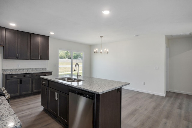 kitchen with hardwood / wood-style floors, a center island with sink, sink, and dishwasher