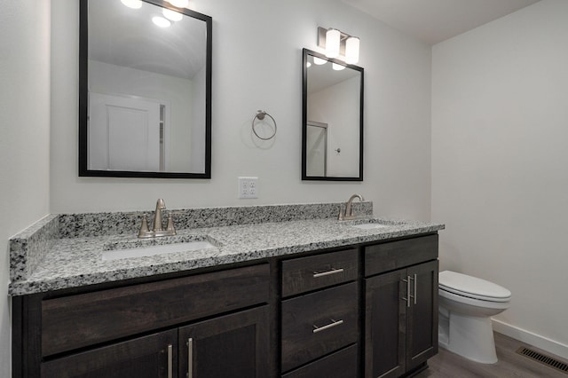 bathroom featuring hardwood / wood-style floors, vanity, and toilet