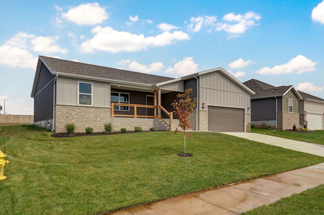 view of front facade with a garage, a porch, and a front lawn