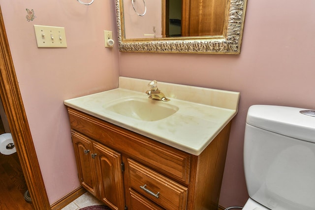 bathroom featuring toilet and vanity