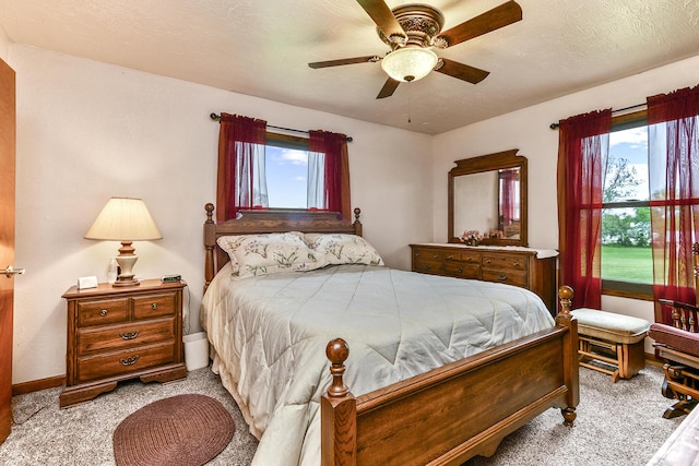 bedroom featuring a ceiling fan and carpet