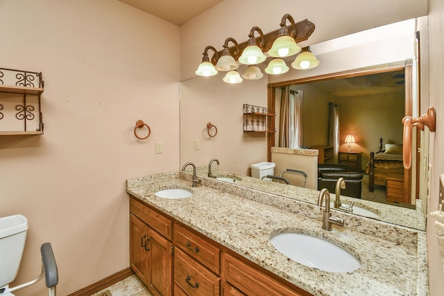 full bath featuring double vanity, toilet, and a sink