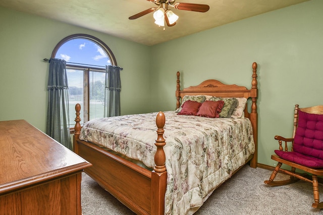 bedroom with a ceiling fan, baseboards, and carpet