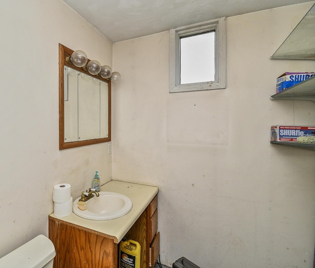 bathroom featuring toilet and vanity