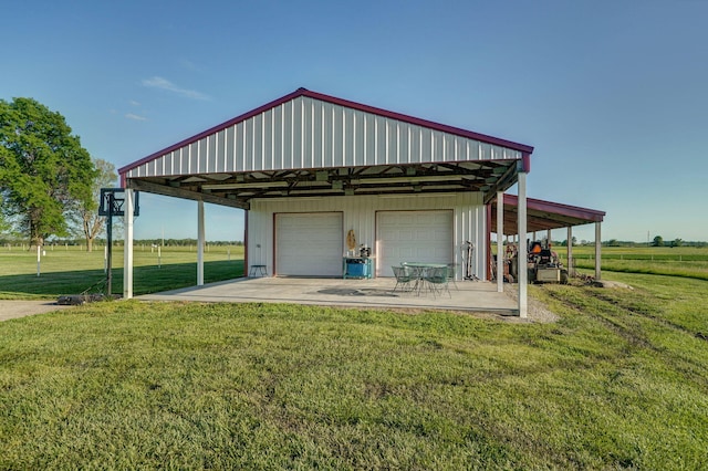 exterior space with a garage, a lawn, and a carport