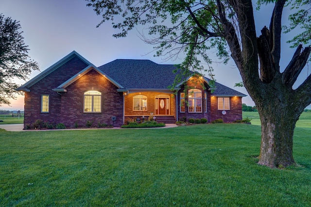 ranch-style home with a yard