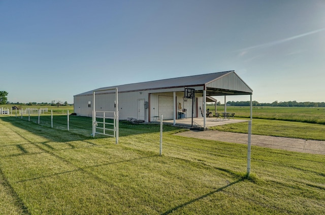 view of outbuilding featuring a yard, a rural view, and a garage